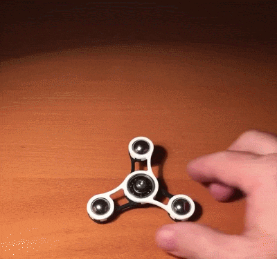 Spinning fidget spinner while take